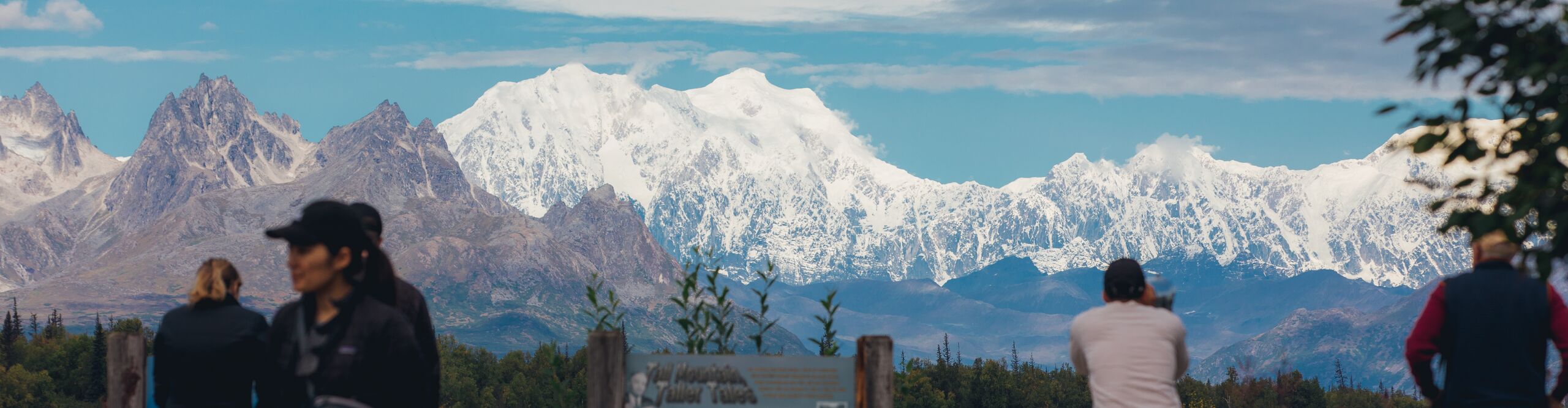 People look out over the snowy mountains of Denali National Park
