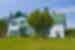 Green Gables Heritage Place, a classic white and green accented 19th century home, with a huge tree in the front yard