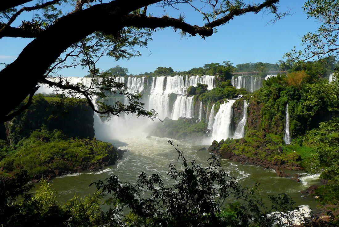 A daylight shot of Iguana Falls viewed through the trees in Argentina.