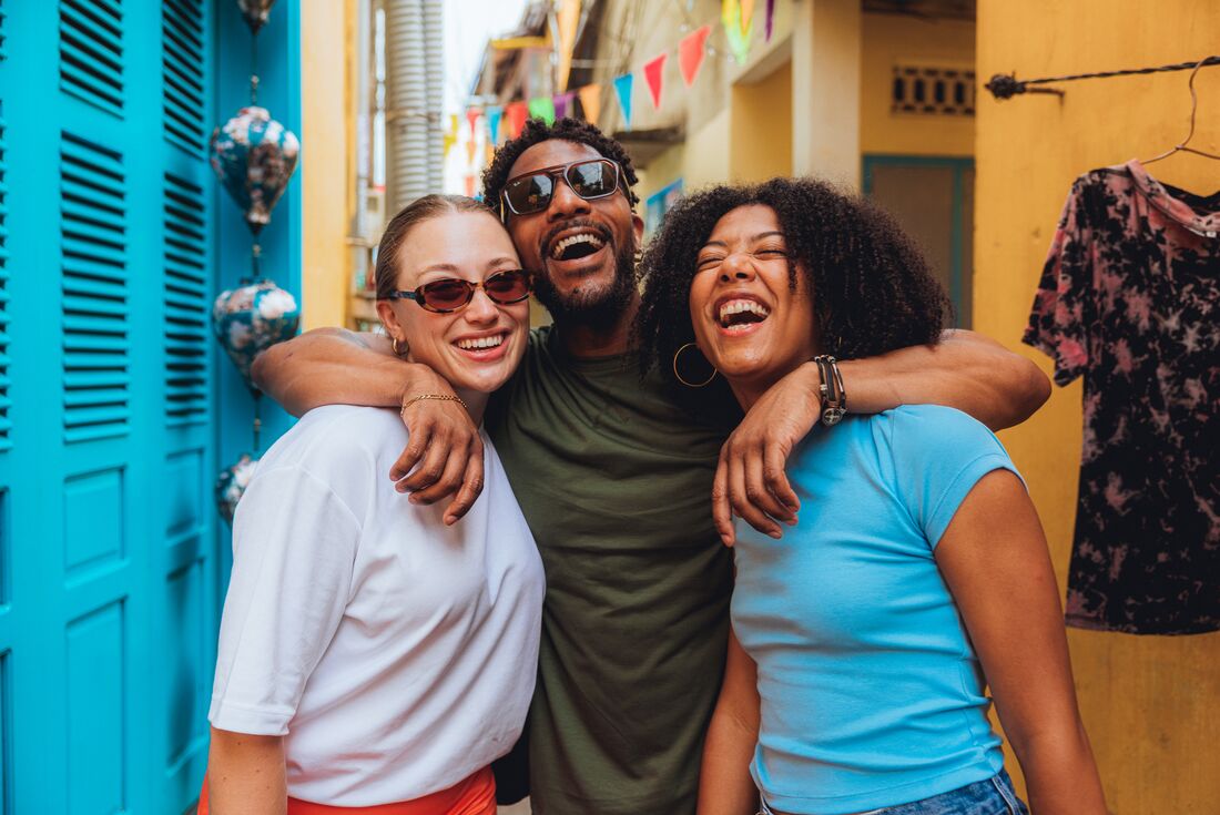 Intrepid Travellers laughing while exploring the colourful Old City of Hoi An, Vietnam
