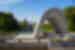 Closeup of arch in Hiroshima Memorial Peace Park with the A-Bomb Dome visible in background