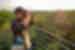 GGPP - Traveller looking through binoculars overseeing Puerto Maldonado, Amazon Jungle