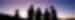 A group of people stand in the foreground of a purple sun set in the West McDonnell Rangers