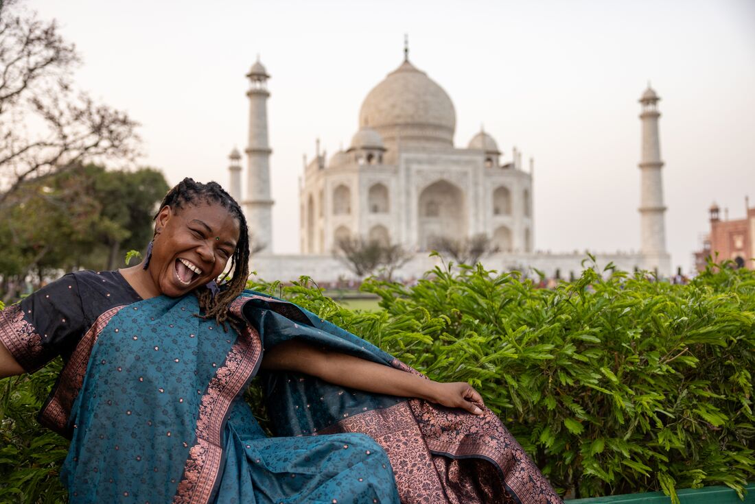 Happy traveller in front of the Taj Mahal in India