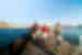 Travellers walk on the pier surrounded by ocean on Naxos in the Aegean Sea in Greece