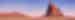Shiprock, at sunset with a pink and purple skin and the rock illuminated in red, New Mexico, USA