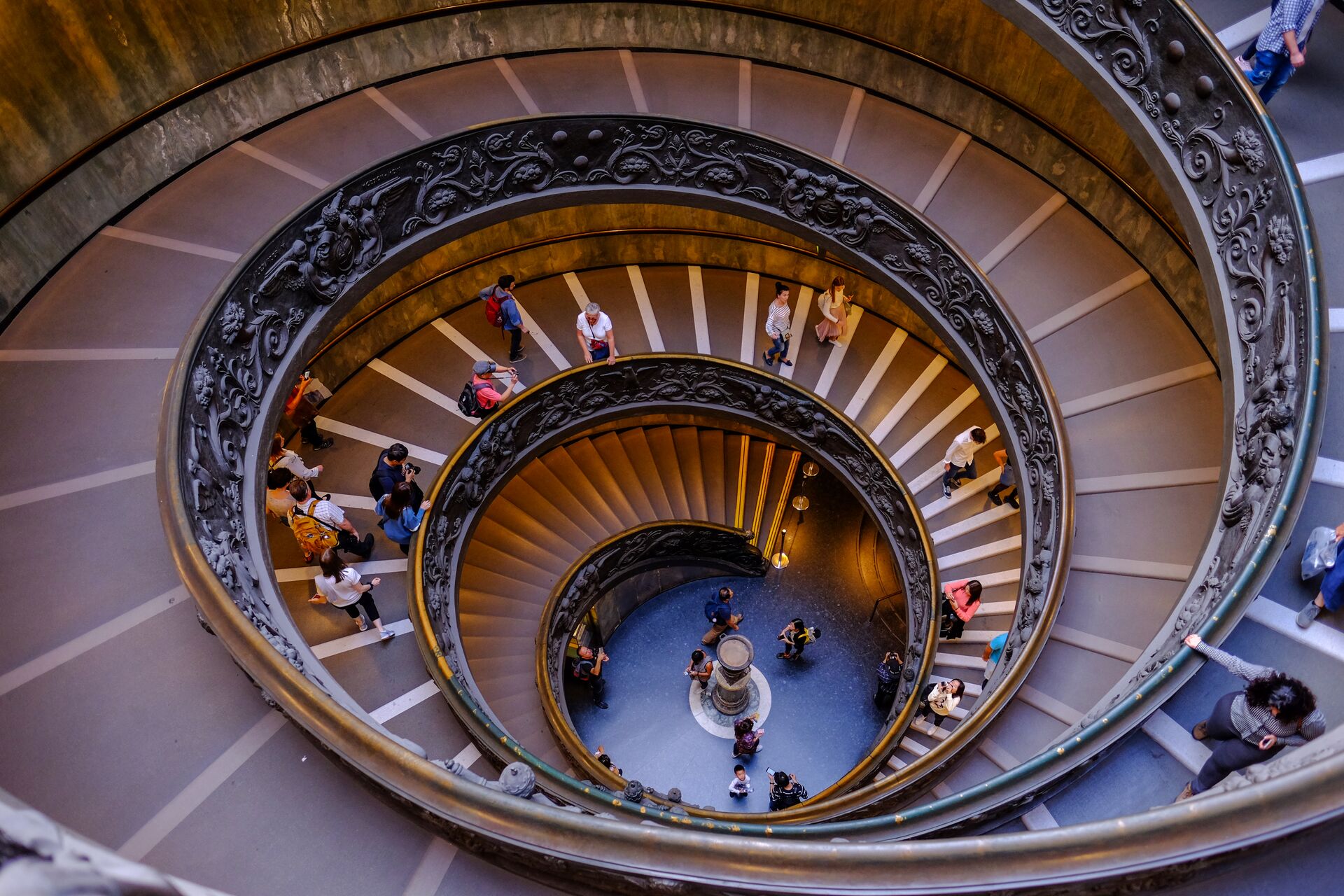Visitors walking the spiral staircase inside the Vatican Museums in Rome
