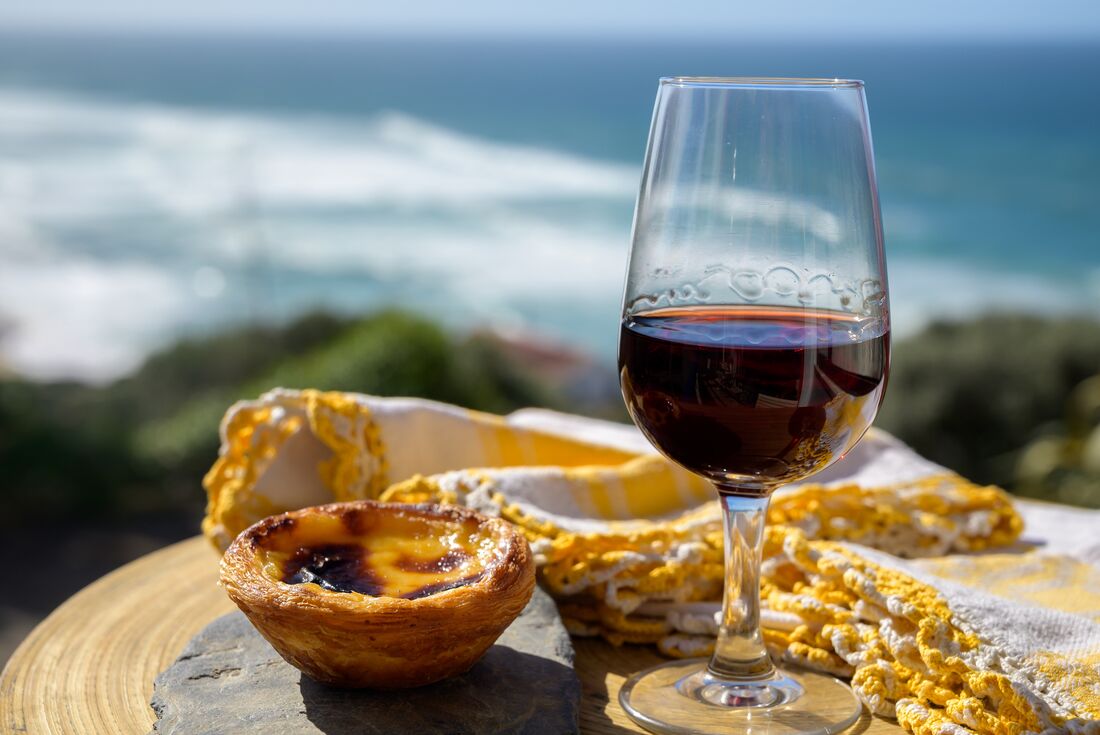 Custard tart and wine by the ocean in Porto, Portugal