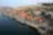 Aerial shot of riverside Porto in Portugal, showing boats docked and colourful building facades