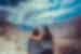 Two female travellers embrace and look out at the hunza mountain ranges