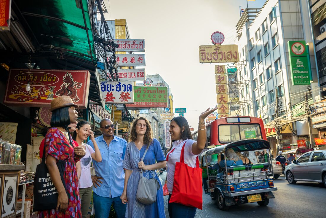 Group of travellers exploring Chinatown in Bangkok, Thailand