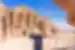 Traveller in a sun hat enjoying the majestic view of the Monastery monument in City of Petra, Jordan