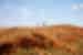 Travellers walking a high orange ridgeline in the Kimberley Western Australia