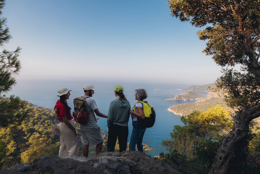A group of travellers stop at a lookout over the ocean along the Lycian Way.