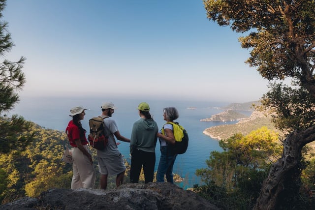 A group of travellers stop at a lookout over the ocean along the Lycian Way.
