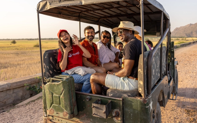Travelers laughing inside a vehicle in India