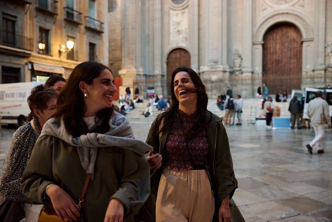 Travellers laughing as they take a walk in Granada, Spain