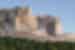 Crazy Horse Memorial mountain as seen from a distance, with the face and arm visible
