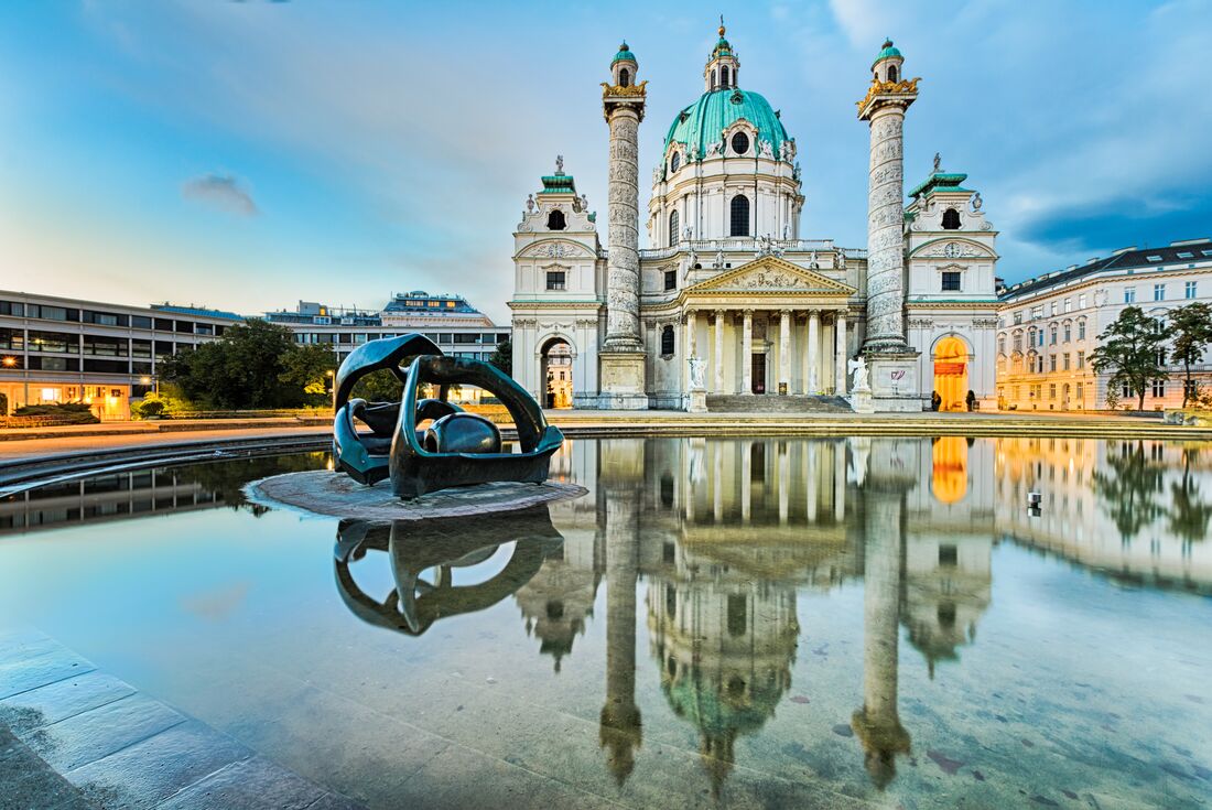 St Charles Church with reflection in water, Vienna, Austria 