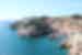 A ultra-wide shot of Fort Lovrijenac, a square fortress, on a rocky coastal cliff on a sunny day