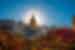 Mosque minaret tower in front of the sun with flowers in the streets of As-Salt