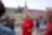 Group of travellers laugh as leader smiles in streeets of Madrid, Spain