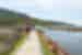 A string of Intrepid travellers hike the paths along Abel Tasman National Park coastline in New Zealand