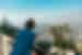 Intrepid Travellers look out over the city skyline of Santiago, Chile, surrounded by hazy mountains