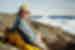 Traveller looks at camera while relaxing at Sisimiut near Ilulissat