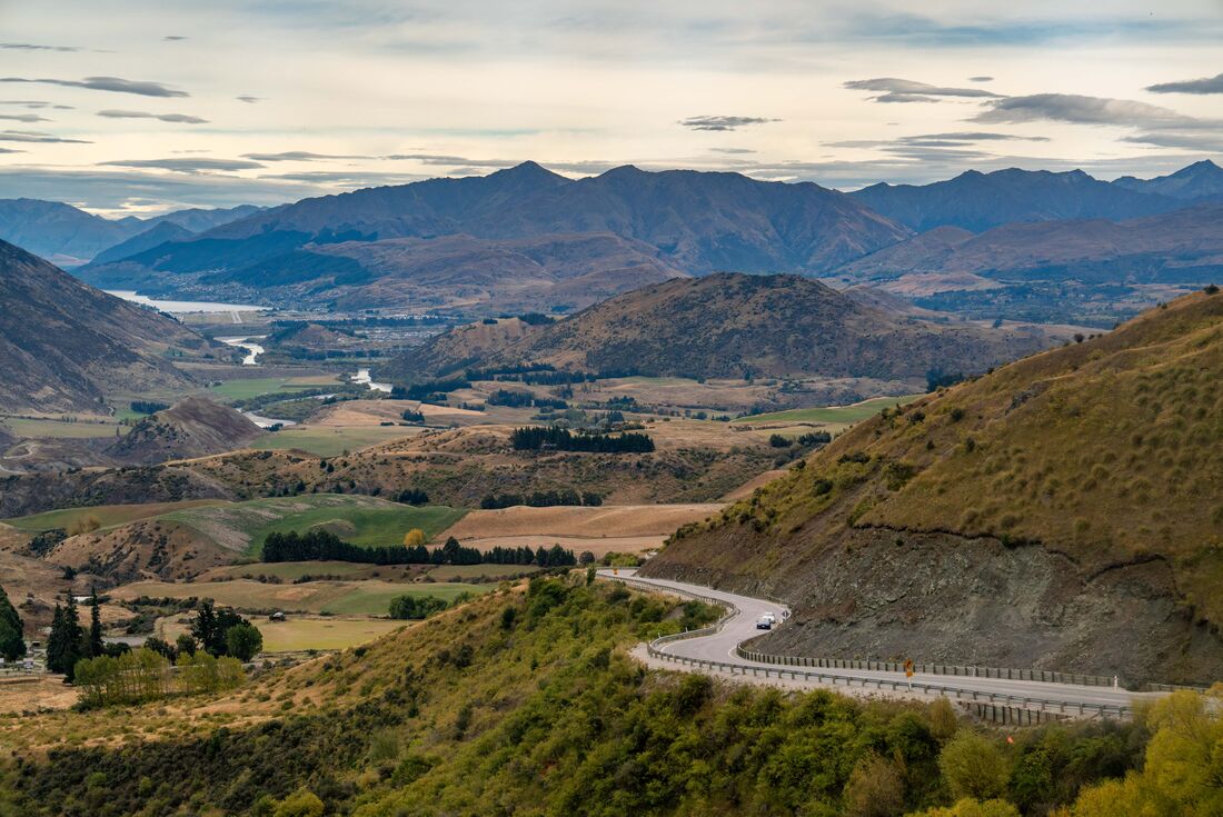 Winding road running through mountainous terrain of Queenstown, New Zealand