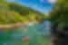Group of travellers in double canoes row into Lake Shikotsu