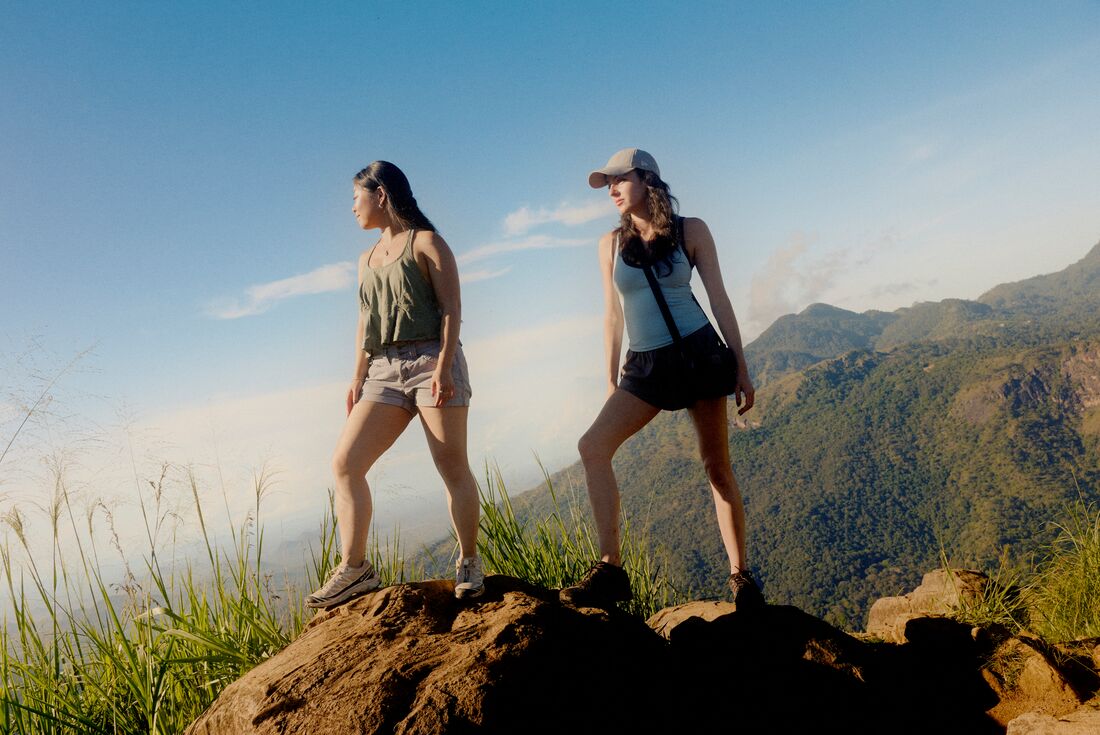 Intrepid Travellerstaking a break to take in the view while hiking at Ella's Rock in Sri Lanka