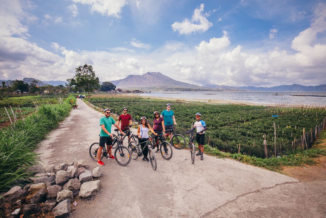 Cycling travellers break for a photo in Bali