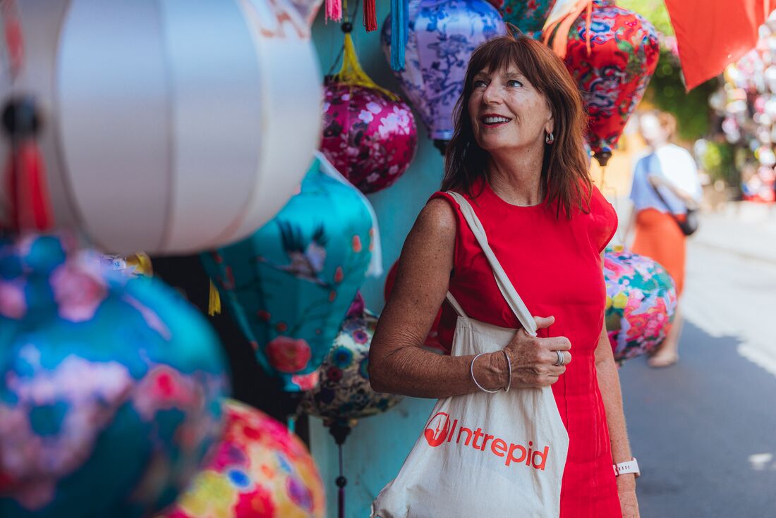 Smiling traveller looking at lanterns in Hoi An, Vietnam