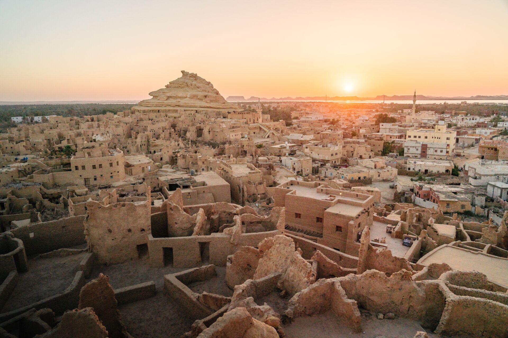 Looking out over ancient Shali town and Mount Shali at sunset, the ancient origins of Siwa Oasis from 1203
