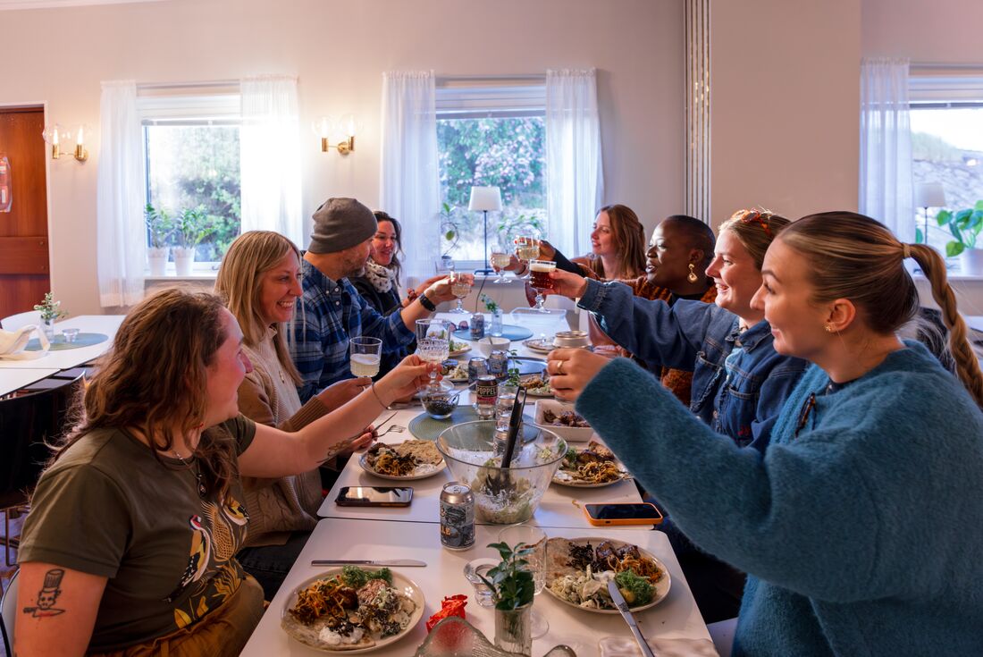Intrepid group of travellers cheers drinks over a fine dinner in Sweden
