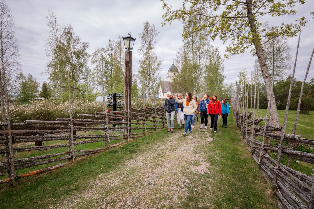 Intrepid Travellers being led by local resident in village safar in Vikarbyn, Sweden