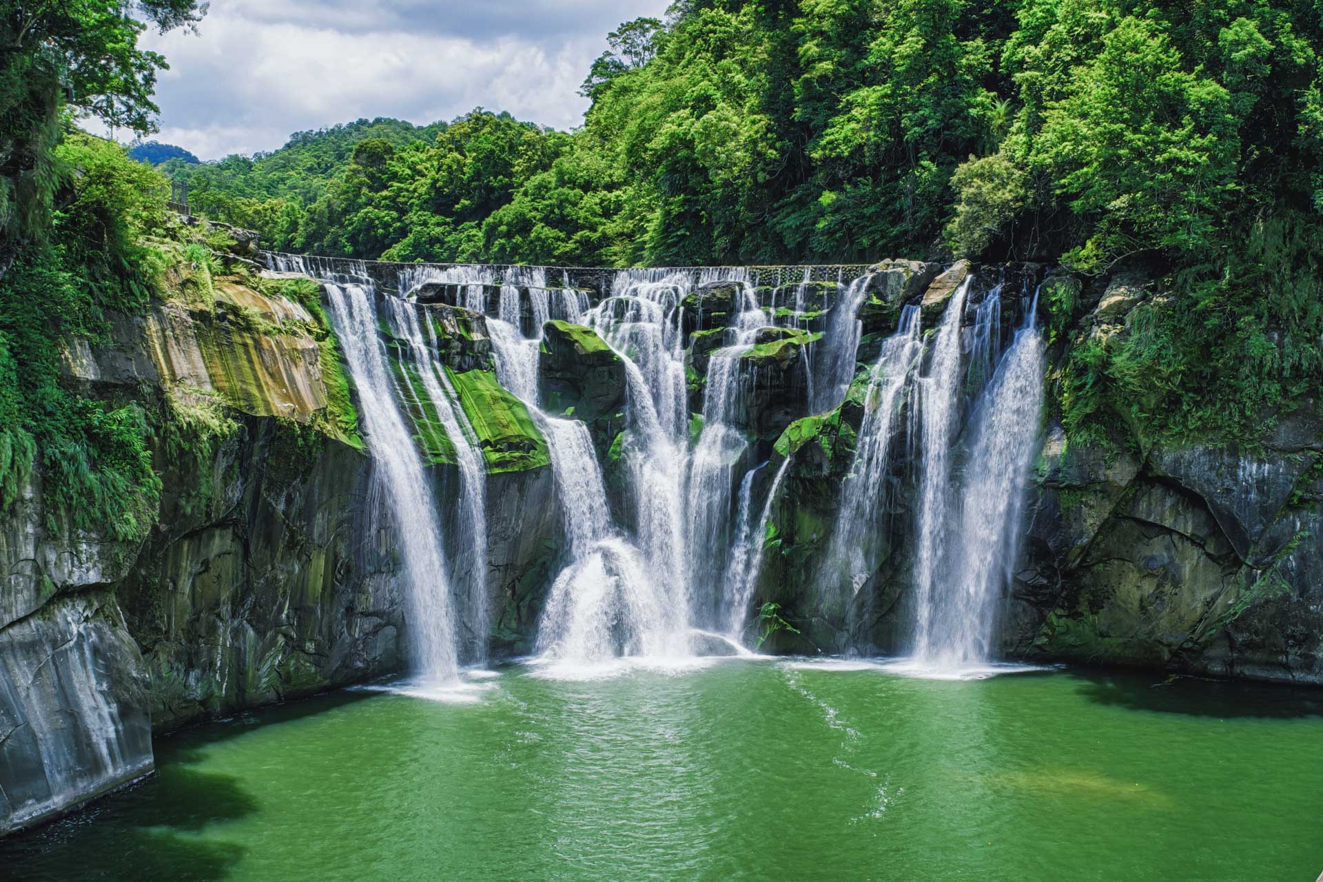 Take in the majesty of Shifen Waterfall cascading in Taiwan's forestsa