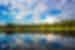 Boat with travellers canoeing on a lake in the scale of Aukstaitija National Park, Lithuania