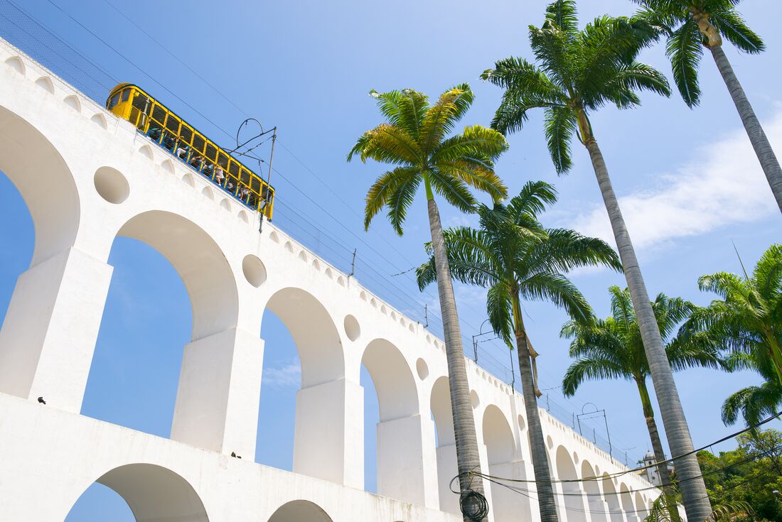 A yellow tram crosses the Arcos da Lapa in Rio de Janeiro, Brazil.