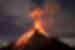 Volcano Fuego eruption seen from the slopes of Fuego, with Antigua's lights behind