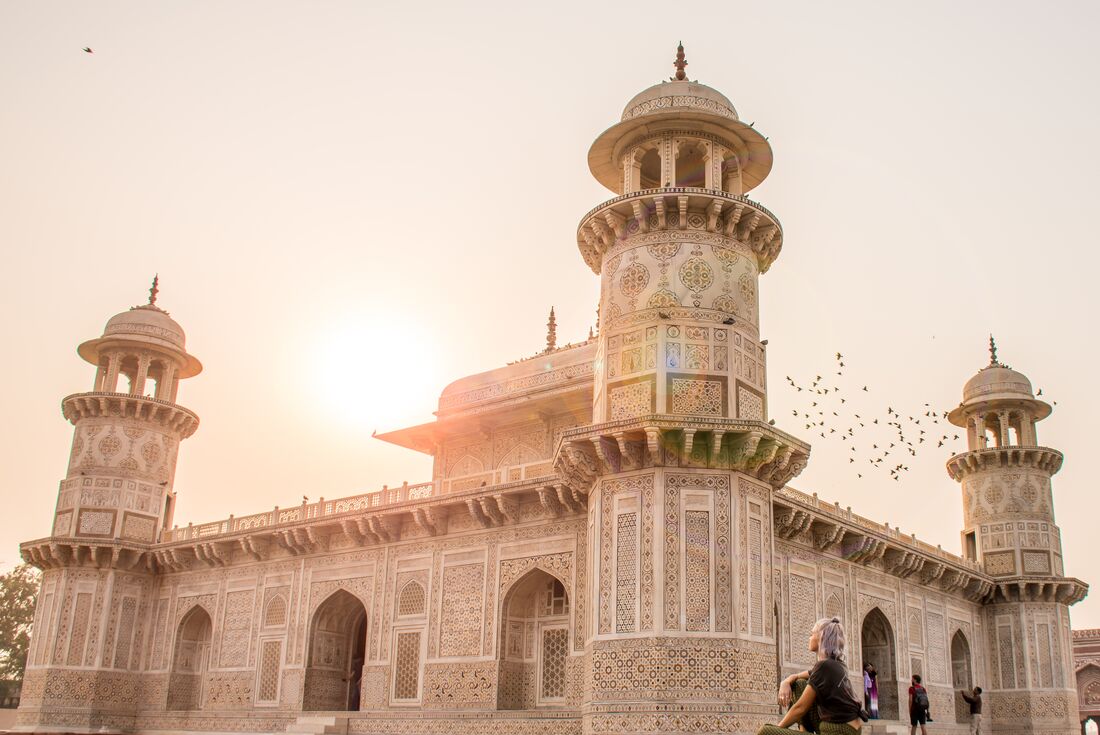 Traveller sits by Agra and watches sunrise